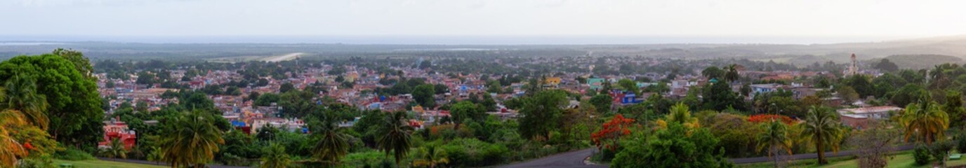 Naklejka premium Aerial Panoramic view of a small touristic Cuban Town during a colorful and cloudy sunset. Taken in Trinidad, Cuba.
