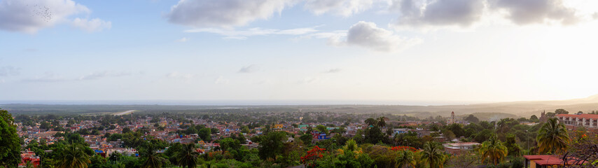 Fototapeta premium Aerial Panoramic view of a small touristic Cuban Town during a colorful and cloudy sunset. Taken in Trinidad, Cuba.