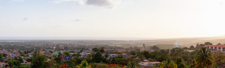Fototapeta premium Aerial Panoramic view of a small touristic Cuban Town during a colorful and cloudy sunset. Taken in Trinidad, Cuba.