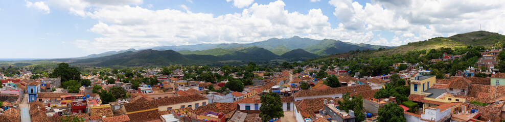 Naklejka na ściany i meble Aerial panoramic view of a small touristic Cuban Town during a sunny and cloudy summer day. Taken in Trinidad, Cuba.