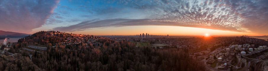 Aerial Panoramic View of a modern city during a colorful and cloudy sunset. Taken in Burnaby, Greater Vancouver, British Columbia, Canada.