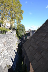 two inclined surfaces: ledge of the fortress wall and tiled roof of the old house