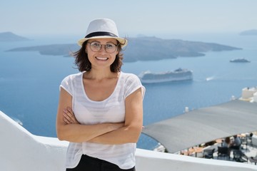 Fototapeta na wymiar Happy mature woman tourist traveling on famous island Santorini