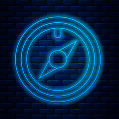 Glowing neon line Wind rose icon isolated on brick wall background. Compass icon for travel. Navigation design. Vector Illustration