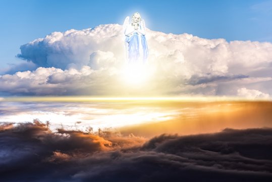 Angel in the clouds . Blue sky with clouds . religion background