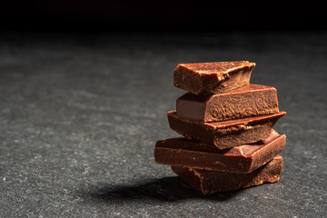 dark chocolate on a stone. Dark background