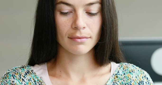 woman in office taking a pause to think