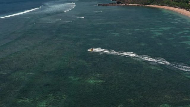 Aerial top view of jet ski racing on a crystal clear water. Extreme enjoying summer vacation. People are playing a water scooter in open sea waters. Watercraft adventure fresh day in summer holiday.