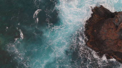 Beautiful view of the turbulent ocean and cliff off the coast of the island of Tenerife. Aerial photo