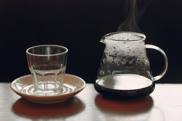 Coffee with steam in flask and glass