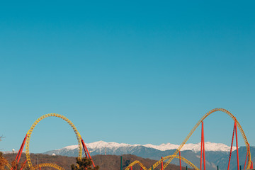 Roller coaster on a background of mountains