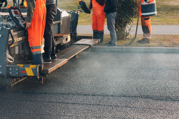 Asphalt paving. Paver machine and workers. New road construction.