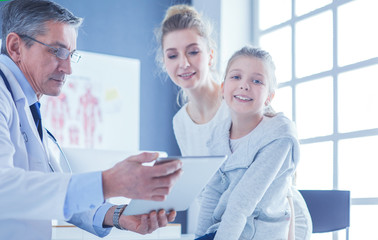 Fototapeta premium Portrait of a cute little girl and her doctor at hospital