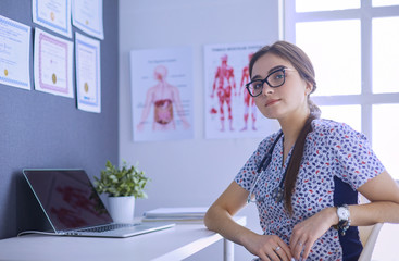 Two doctors speaking in a bright office