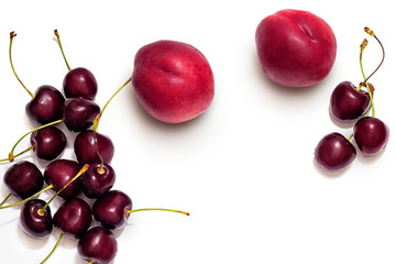 Juicy nectarine and ripe sweet cherries isolated on white background