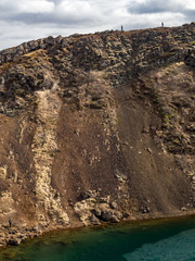 Hikers walk the rim of the Kerid crater in Iceland