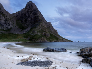 The midnight sun lights up a beach at night in Lofoten, Norway