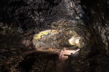 Illuminated lava tunnels in Sao Vicente Caves and Volcano Center. Result of the ancient volcanic eruption and magma flow now presented to tourists.