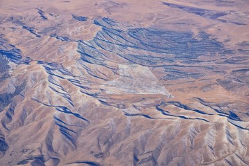 Fototapeta premium Colorado Rocky Mountains Aerial view from airplane of abstract Landscapes, peaks, canyons and rural cities in southwest Colorado and Utah. United States of America. USA.