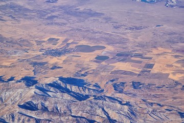 Fototapeta premium Colorado Rocky Mountains Aerial view from airplane of abstract Landscapes, peaks, canyons and rural cities in southwest Colorado and Utah. United States of America. USA.