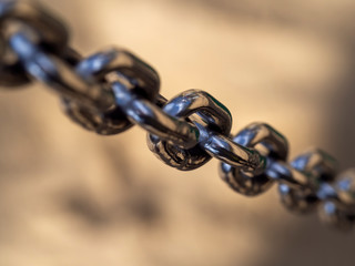 Fototapeta premium shiny chrome chain front of the blurry background
