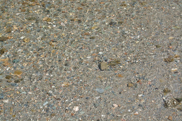 Small stone in the water of the Ionian Sea