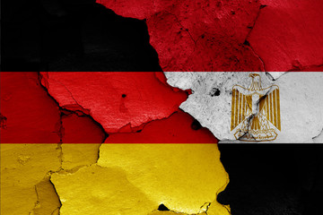 flags of Germany and Egypt painted on cracked wall