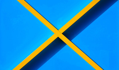 A bright yellow cross on a light blue background.