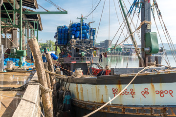 Fototapeta na wymiar Fishing trawler is moored at the Tai Kak Pier in the industrial estate of the Ranong harbor