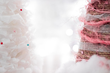 Soft focus bright christmas background with copy space. Handmade xmas trees from white lace on white bokeh background.