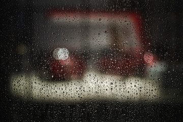 Background photo of rain drops on dark glass, different size: small medium and large horizontal view