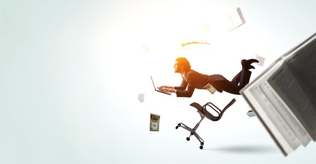 Man flies and works on laptop. Mixed media