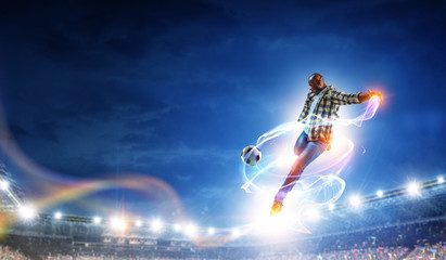 Soccer man in action with ball. Mixed media