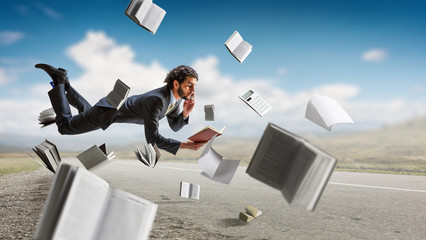 Man flies and works on laptop. Mixed media