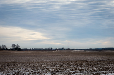 Winter agricultural field with a little snow