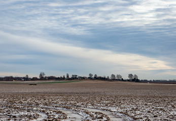 Winter agricultural field with a little snow