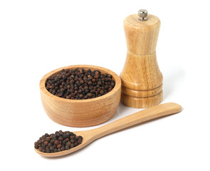 Black pepper in wooden bowl and spoon with wooden pepper mill isolated on white background