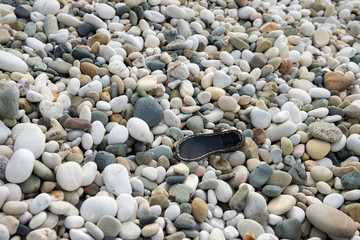 Shoe sole on a rocky beach.