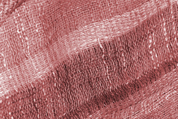Cotton scarf texture close up. Textile background brown color toned