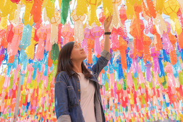 A portrait of Asian woman with colorful lanterns or lamps during travel trip and holidays vacation...