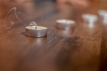 The candle went out letting out smoke.