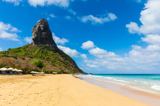 View of the most recognized peak of Fernando de Noronha called Morro do Pico seen from popular Conceicao beach.