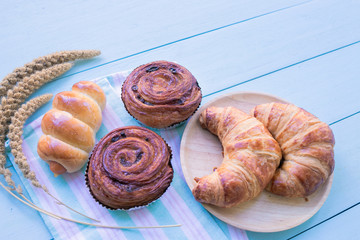 Fresh bread on wooden table background. Top view with space for your text.