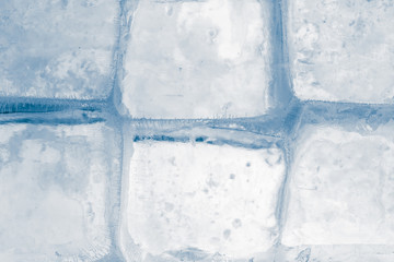 Ice texture background. Textured frosty surface of ice blocks against white.