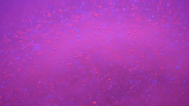 Colorful Bubbles Oil Beautiful Paint Universe Color Moving Multicolored. Holiday Background. Christmas. Galaxy Nebula Space Stars Planets. Milky Way. Fantastic surface with Chaotic motion liquid.