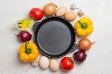 Frying pan. A set of vegetables for a healthy diet, yellow and red peppers, tomatoes, onions, garlic.  .