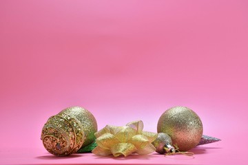christmas balls with stars on pink background