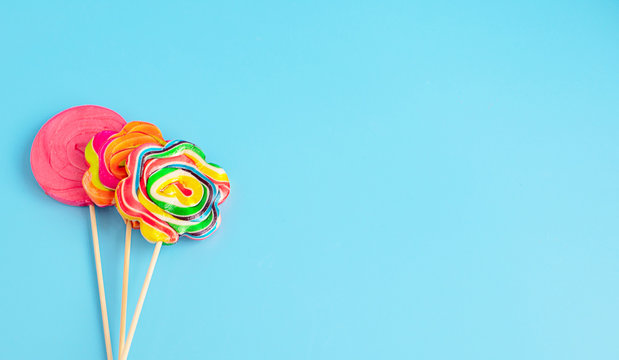 three Lollipop on a blue background, copy space