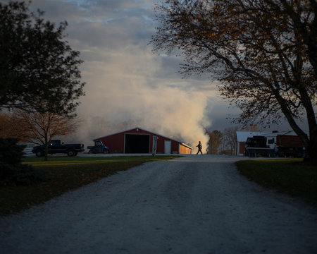 Smoke rises from burning leaves on a farm in the midwest