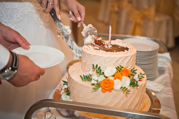 The process of cutting a delicious birthday cake decorated with flowers fr